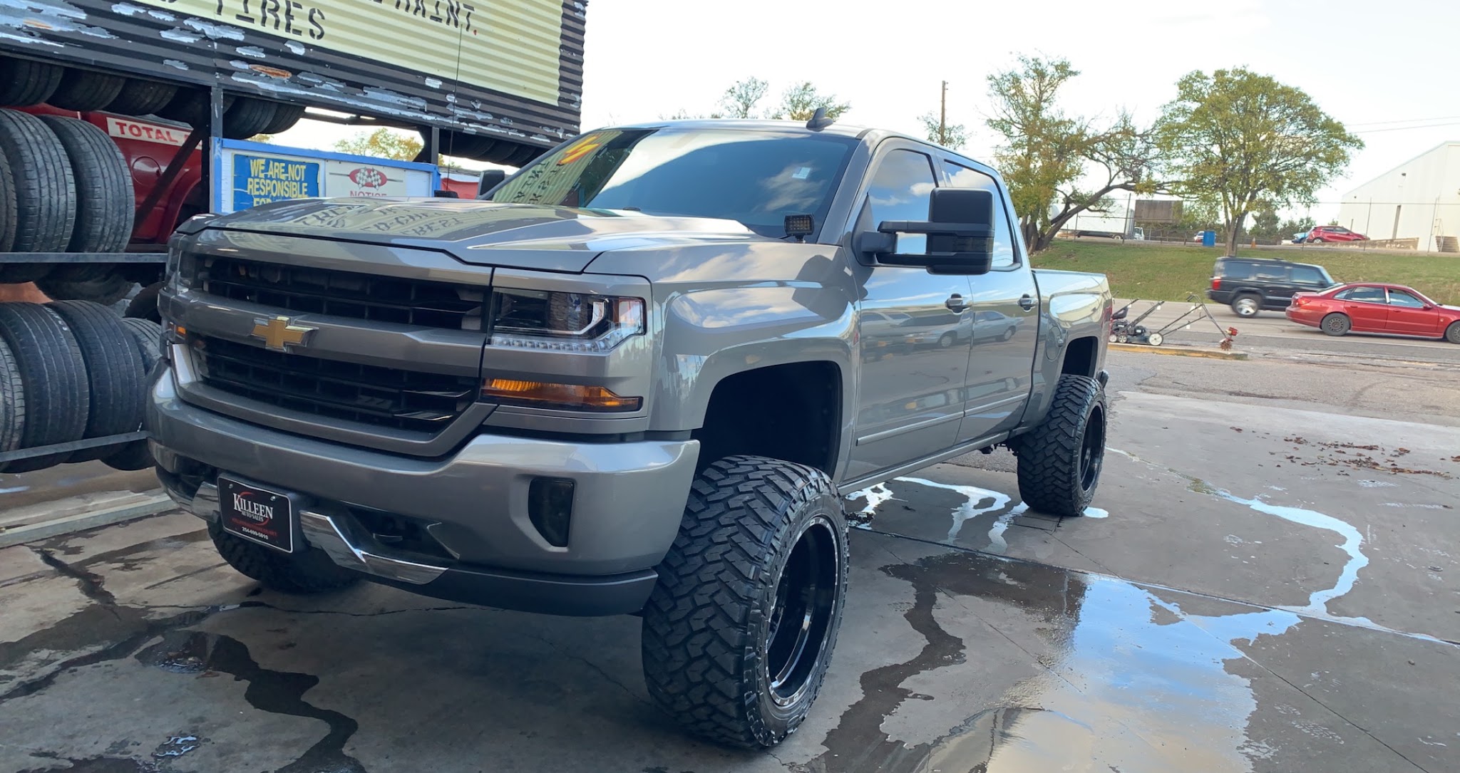 Lifted truck with off-road tires at Al's Super Center